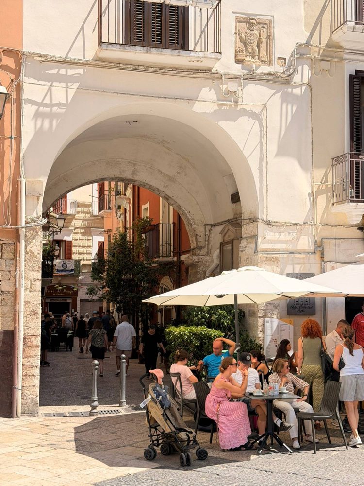 A cafe under a white arch in old Bari