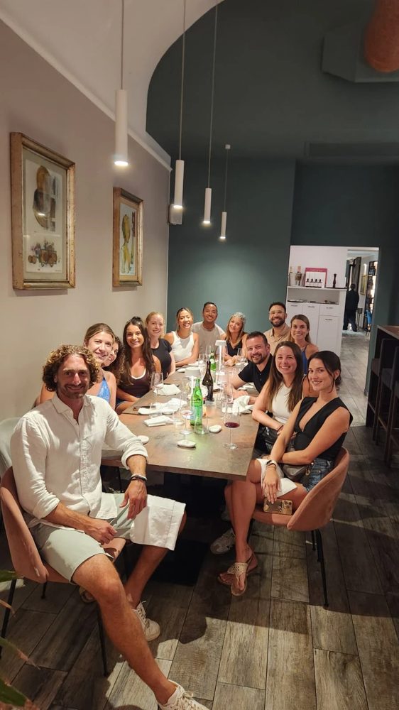 The crew down a long restaurant table in Bari