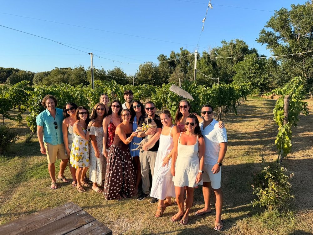 The crew among the vines at a vineyard evening outside Bari