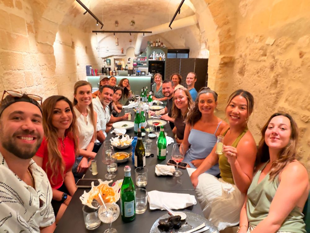 Dinner down a long table under a stone vault in Matera